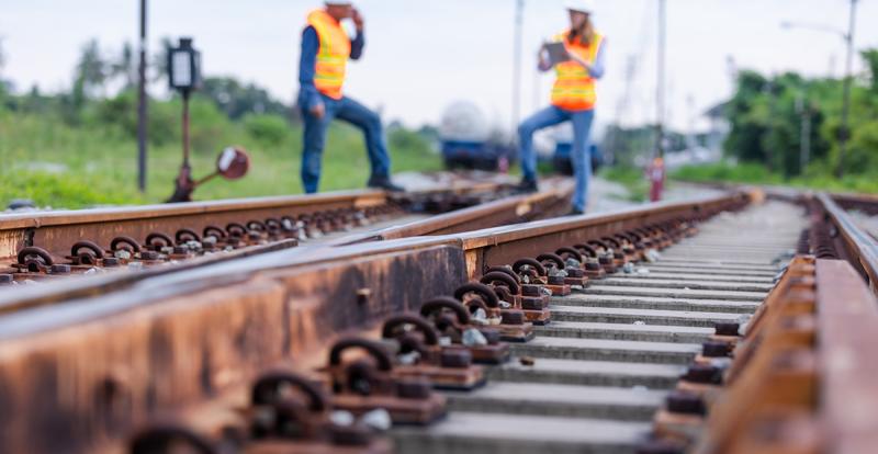 Two engineers inspecting railroad track