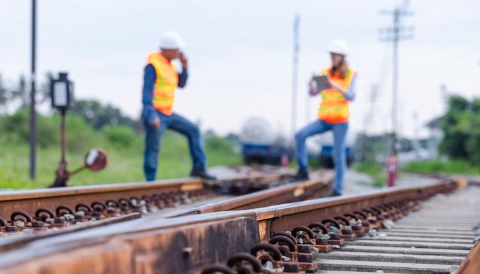 Two engineers inspecting railroad track